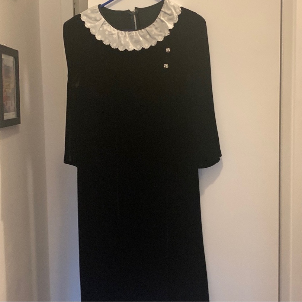 Vintage black velvet dress with decorative buttons.